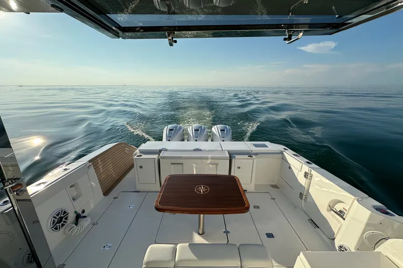 Slide: The Image of 2024 Pursuit OS 445 Offshore boat cruising on calm ocean waters. - 39