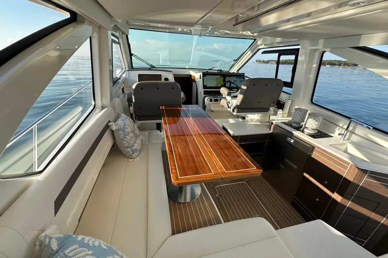 Slide: The Image of Luxurious interior of 2024 Pursuit OS 445 Offshore yacht with elegant seating and wooden table. - 4