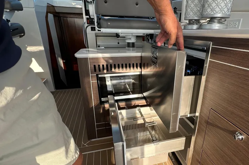 Slide: The Image of 2024 Pursuit OS 445 Offshore yacht interior with open stainless steel drawers and cabinetry. - 43