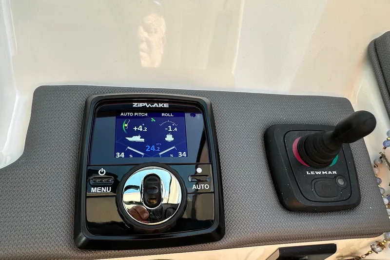 Slide: The Image of 2024 Pursuit OS 445 Offshore control panel with Zipwake and Lewmar systems. - 57