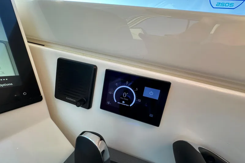 Slide: The Image of 2024 Pursuit OS 445 Offshore dashboard with Garmin display and control panel. - 58