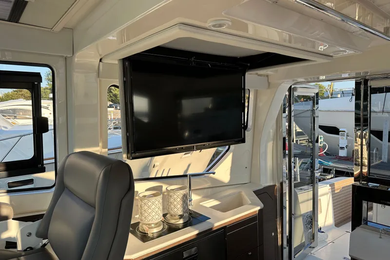 Slide: The Image of Luxurious interior of 2024 Pursuit OS 445 Offshore yacht with TV and seating area. - 63