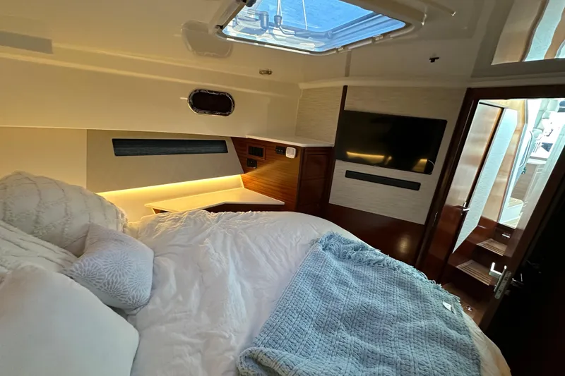Slide: The Image of Luxurious 2024 Pursuit OS 445 Offshore cabin with cozy bedding and modern amenities. - 66