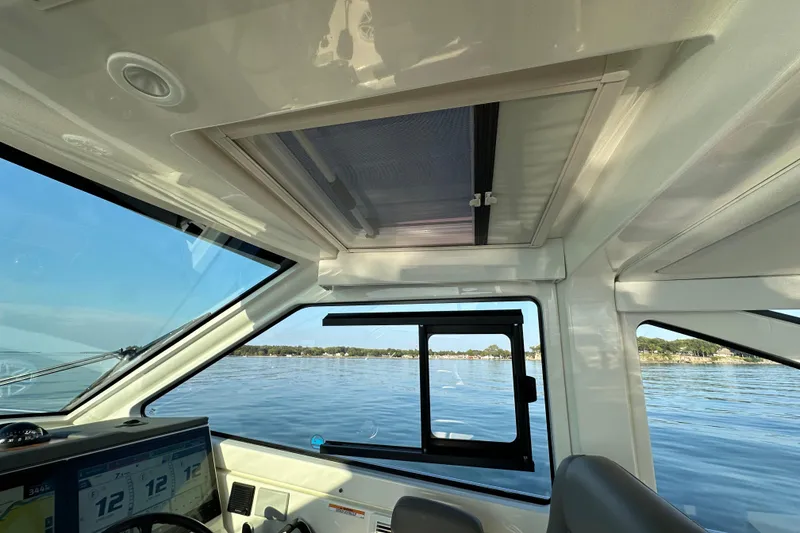 Slide: The Image of 2024 Pursuit OS 445 Offshore cabin interior with ocean view through windows. - 9