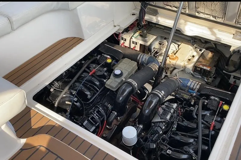 Slide: The Image of Engine compartment of 2003 Cruisers Yachts 3470 Express, showcasing dual engines and components. - 35