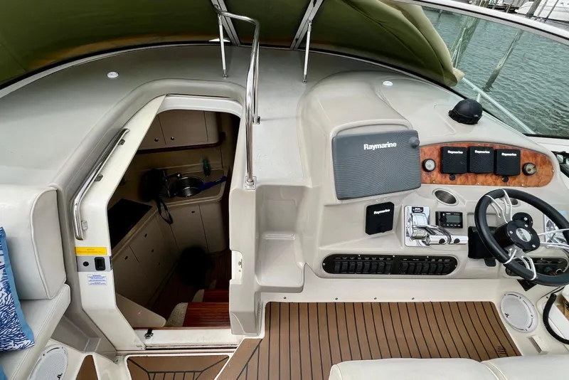 Slide: The Image of 2003 Cruisers Yachts 3470 Express helm with Raymarine electronics and cabin entrance. - 7