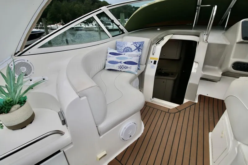 Slide: The Image of 2003 Cruisers Yachts 3470 Express interior with seating, cushions, and potted plant. - 12