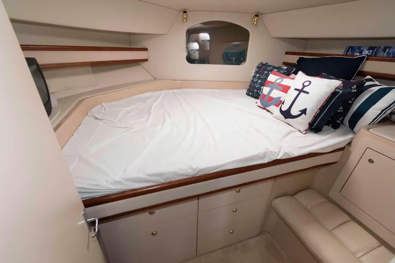 Slide: The Image of 1999 Cruisers Yachts 3750 Motoryacht cabin with nautical-themed bedding and cozy interior. - 14