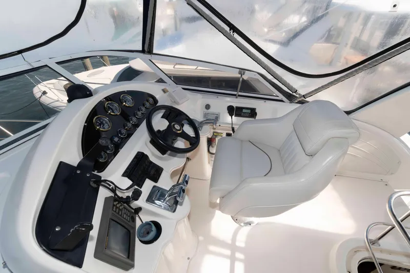 Slide: The Image of 1999 Cruisers Yachts 3750 Motoryacht helm with steering wheel and control panel. - 5