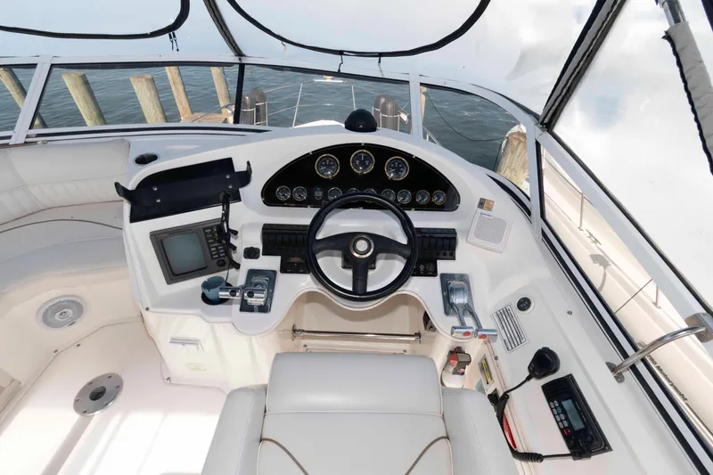 Slide: The Image of 1999 Cruisers Yachts 3750 Motoryacht helm with steering wheel and navigation controls. - 6