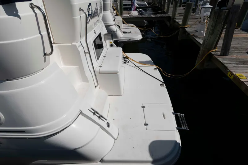 Slide: The Image of 1999 Cruisers Yachts 3750 Motoryacht docked, showing rear deck and marina setting. - 7