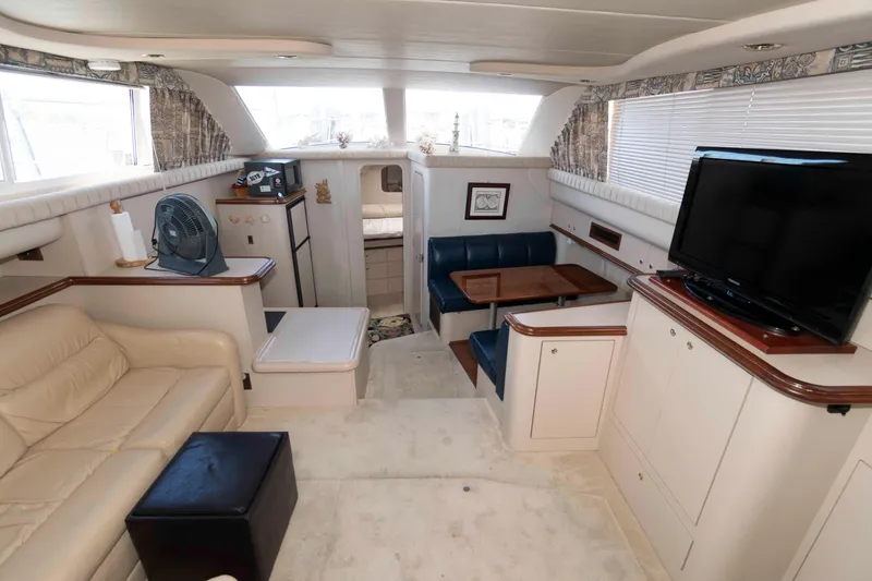 Slide: The Image of 1999 Cruisers Yachts 3750 Motoryacht interior with seating, TV, and dining area. - 8