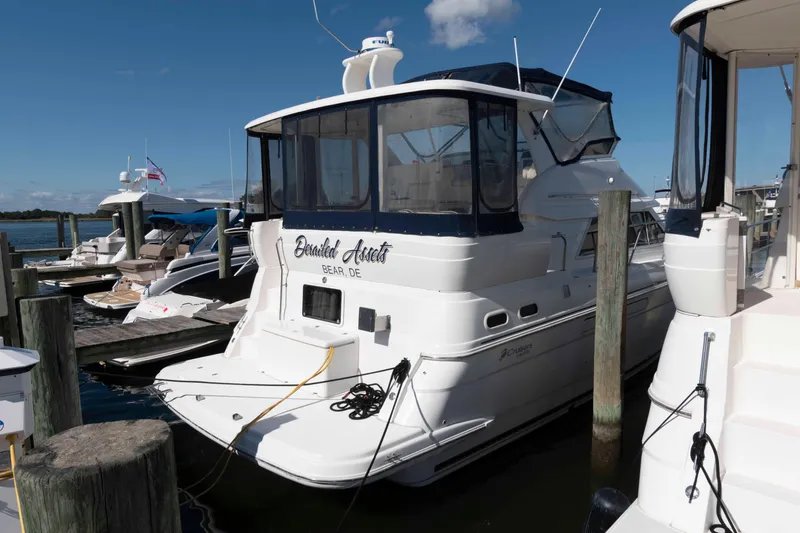 Slide: The Image of 1999 Cruisers Yachts 3750 Motoryacht docked at marina under clear blue sky. - 1