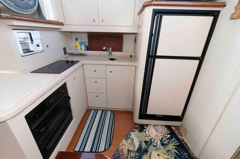 Slide: The Image of 1999 Cruisers Yachts 3750 Motoryacht kitchen with stove, oven, and refrigerator. - 12