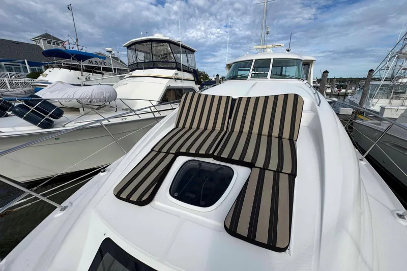 Slide: The Image of 2007 Sea Ray 40 Motor Yacht with striped sun pads docked at marina. - 11
