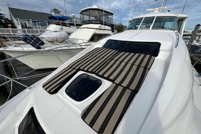 Slide: The Image of 2007 Sea Ray 40 Motor Yacht with striped sun pads docked at marina. - 12