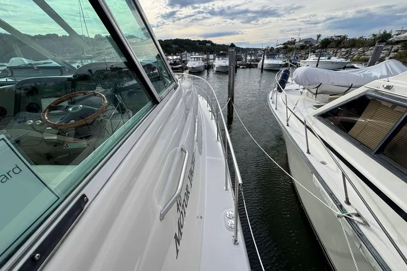 Slide: The Image of 2007 Sea Ray 40 Motor Yacht docked in a marina, showcasing sleek design and steering wheel. - 13
