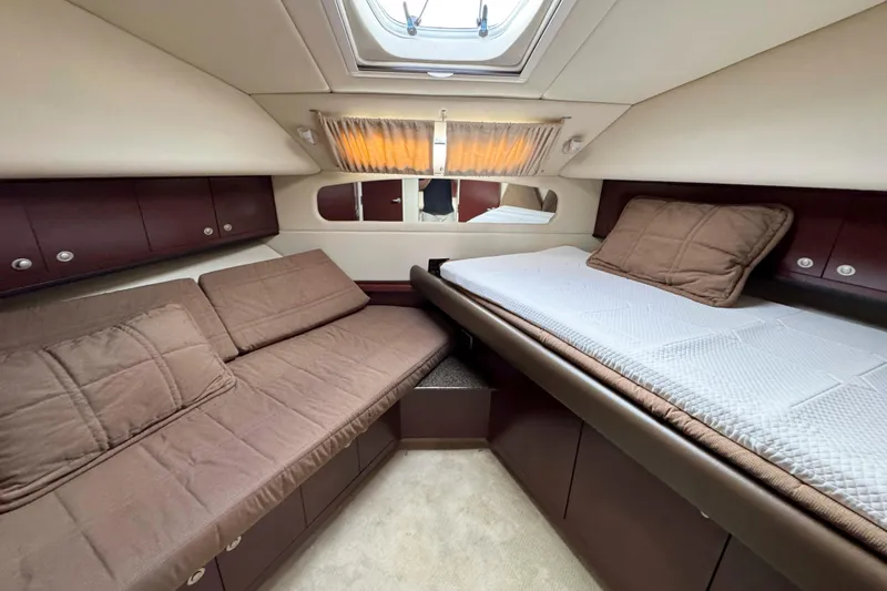 Slide: The Image of Luxurious 2007 Sea Ray 40 Motor Yacht cabin with cozy bedding and elegant wood finishes. - 31