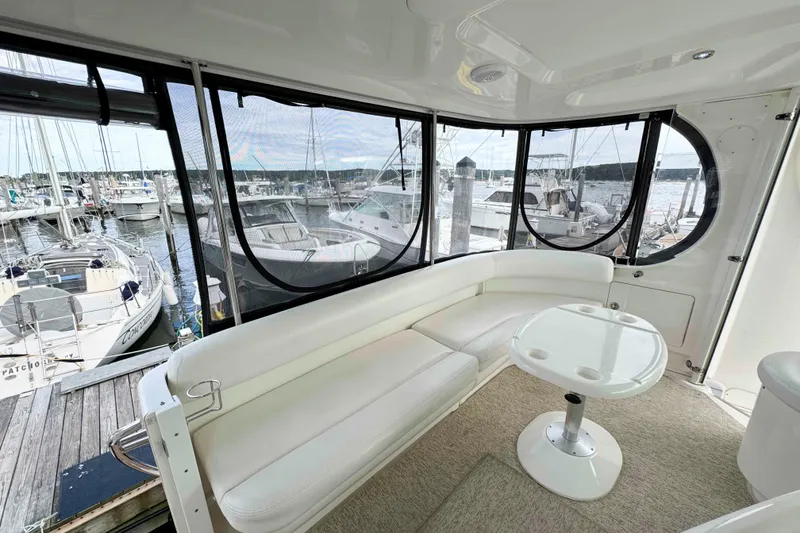 Slide: The Image of 2007 Sea Ray 40 Motor Yacht interior with white seating and marina view. - 4
