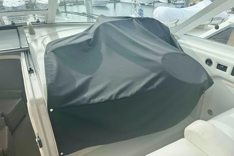 Slide: The Image of 2007 Sea Ray 40 Motor Yacht helm covered with black fabric, docked at marina. - 8