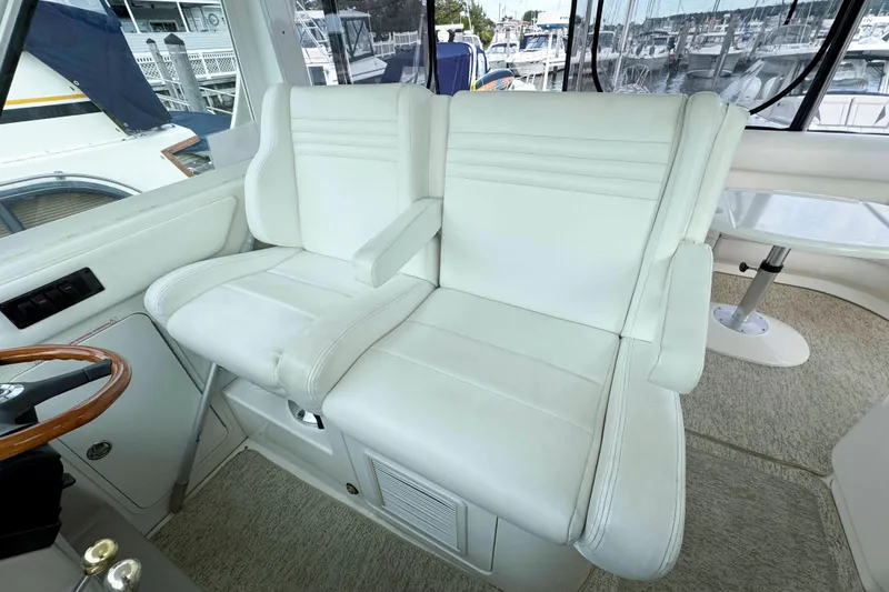 Slide: The Image of Luxurious white seating in 2007 Sea Ray 40 Motor Yacht cockpit, with marina view. - 9