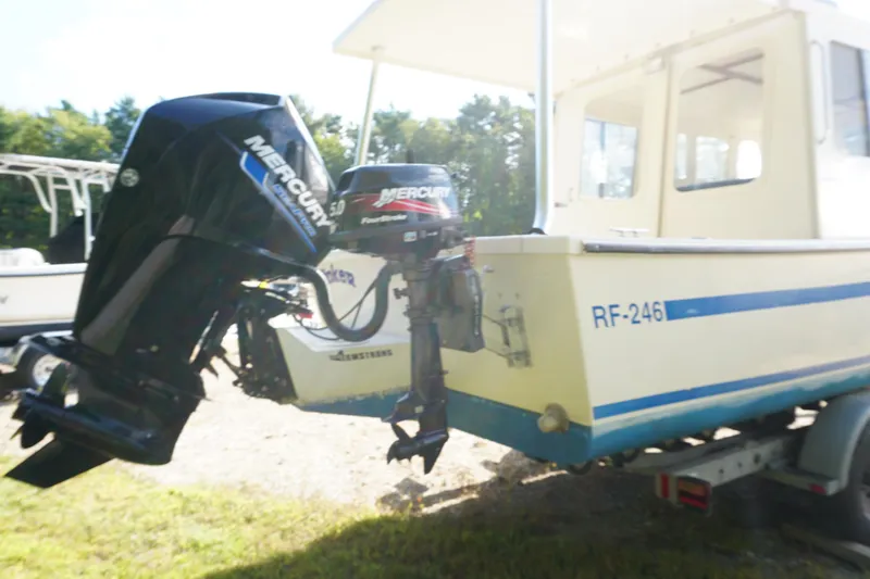 Slide: The Image of 2002 Rosborough RF-246 Sedan Cruiser with Mercury outboard motor on trailer. - 11