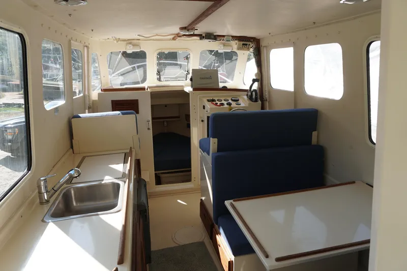 Slide: The Image of 2002 Rosborough RF-246 Sedan Cruiser interior with seating, table, and kitchenette. - 13