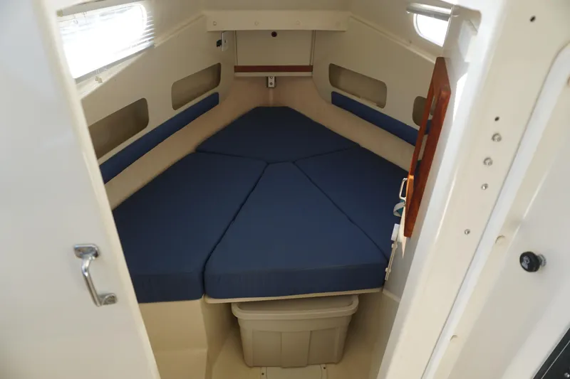 Slide: The Image of 2002 Rosborough RF-246 Sedan Cruiser interior with blue cushioned V-berth. - 16