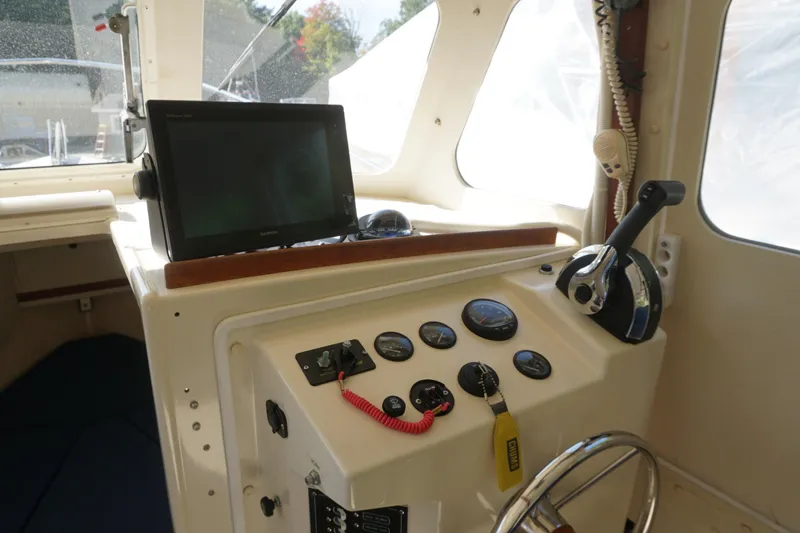 Slide: The Image of 2002 Rosborough RF-246 Sedan Cruiser helm with navigation equipment and controls. - 17