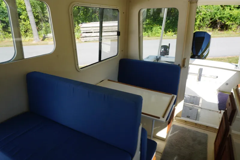 Slide: The Image of Interior of 2002 Rosborough RF-246 Sedan Cruiser with blue seating and table. - 24