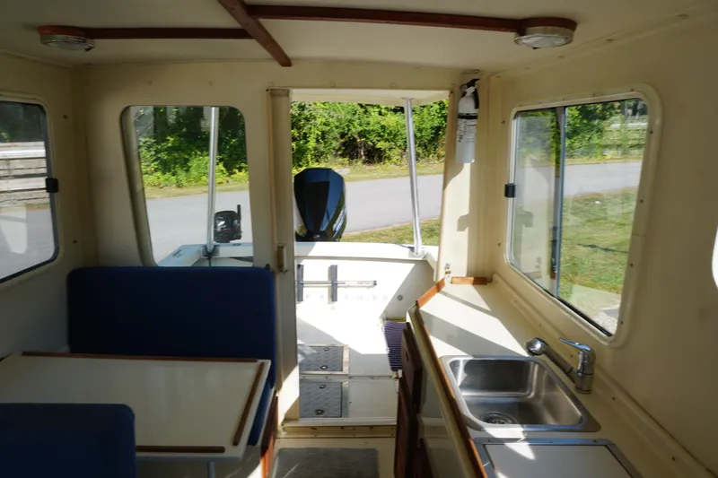 Slide: The Image of Interior of 2002 Rosborough RF-246 Sedan Cruiser with seating and kitchenette. - 25