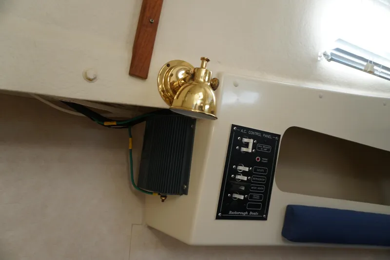 Slide: The Image of 2002 Rosborough RF-246 Sedan Cruiser interior with control panel and brass light fixture. - 30