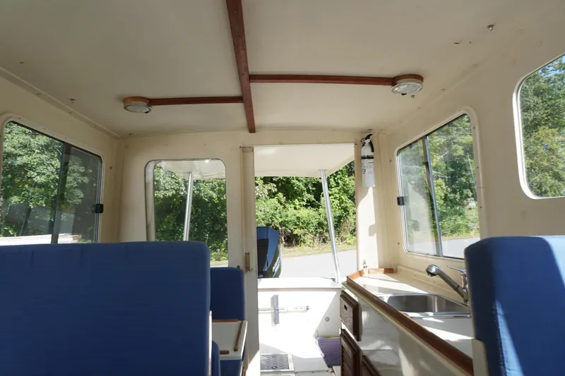 Slide: The Image of Interior of 2002 Rosborough RF-246 Sedan Cruiser with blue seating and kitchenette. - 32