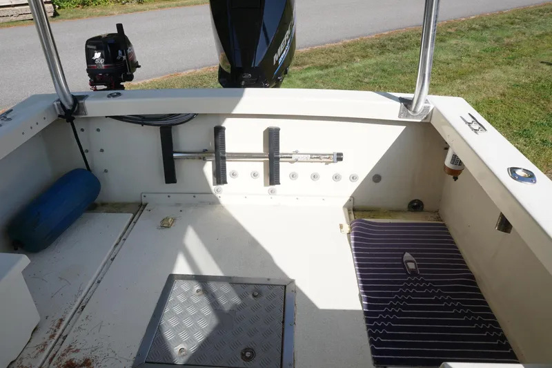 Slide: The Image of 2002 Rosborough RF-246 Sedan Cruiser boat interior with motor and deck features. - 34