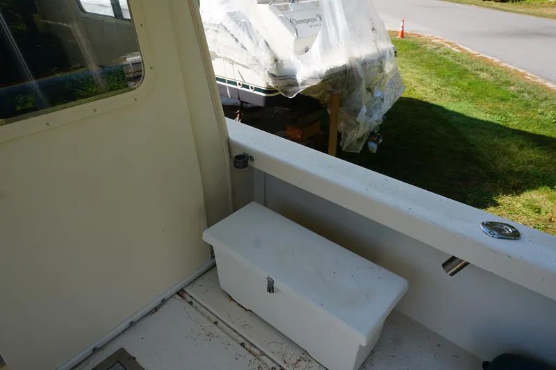 Slide: The Image of 2002 Rosborough RF-246 Sedan Cruiser interior with storage box and outdoor view. - 37