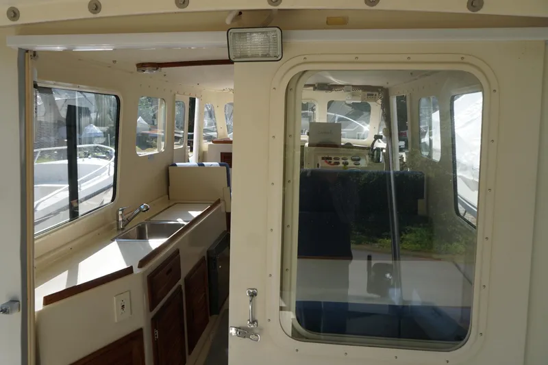 Slide: The Image of Interior view of 2002 Rosborough RF-246 Sedan Cruiser with kitchenette and seating area. - 38