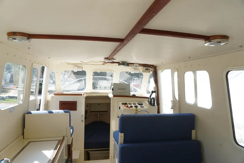 Slide: The Image of Interior of 2002 Rosborough RF-246 Sedan Cruiser, featuring helm and seating area. - 43