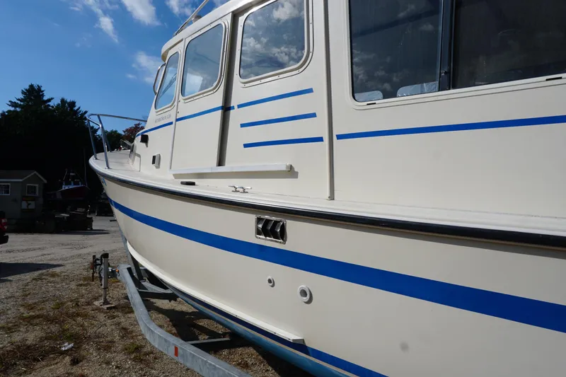 Slide: The Image of 2002 Rosborough RF-246 Sedan Cruiser with blue stripes on a trailer, side view. - 7
