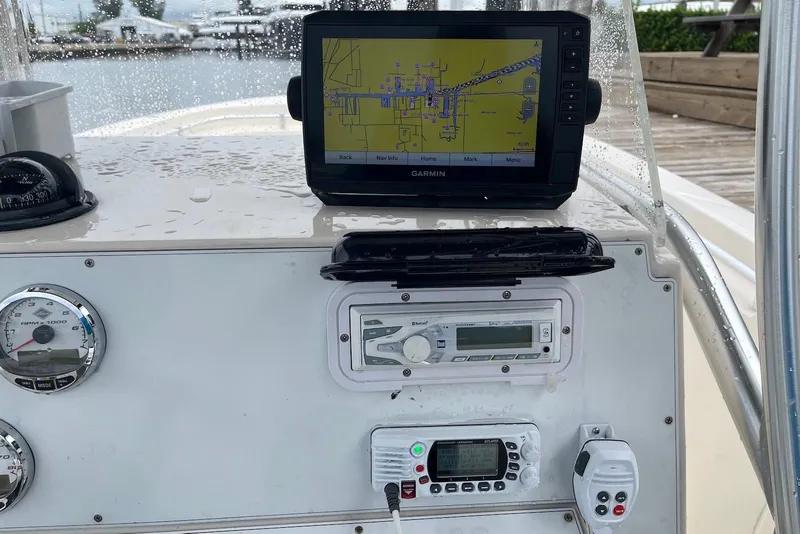 Slide: The Image of 2011 Angler 2600 CC boat dashboard with Garmin GPS, gauges, and radio equipment. - 10