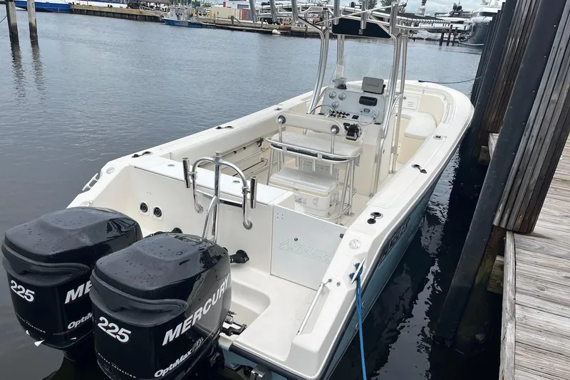 Slide: The Image of 2011 Angler 2600 CC boat docked with twin Mercury engines. - 2