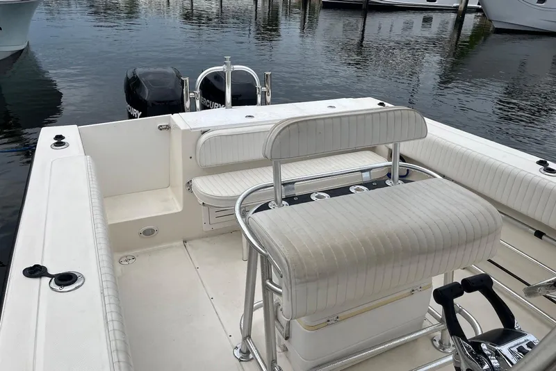Slide: The Image of 2011 Angler 2600 CC boat interior with seating and dual Mercury engines. - 5