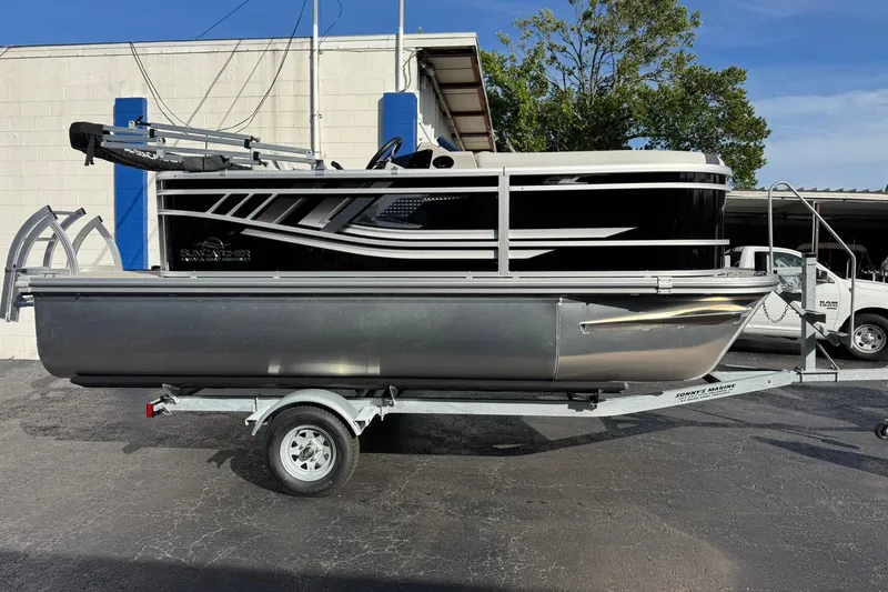 The Image of 2025 SunCatcher Select 16C pontoon boat on trailer, parked outdoors. - 0