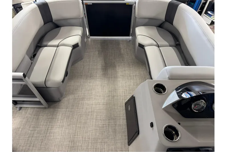 Slide: The Image of 2025 SunCatcher Select 16C pontoon boat interior with gray seating and modern dashboard. - 5