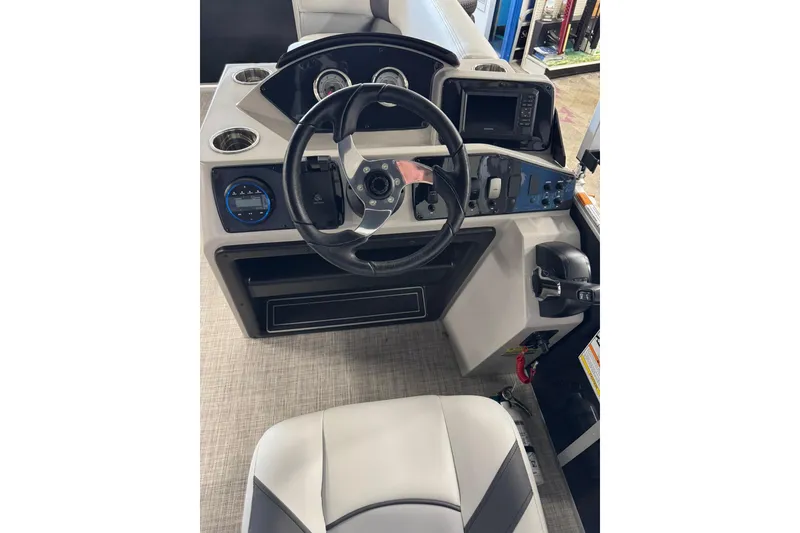 Slide: The Image of 2025 SunCatcher Select 16C boat dashboard with steering wheel and control panel. - 6