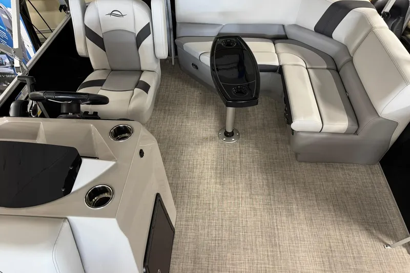 Slide: The Image of 2025 SunCatcher Select 16C boat interior with plush seating and modern helm. - 7