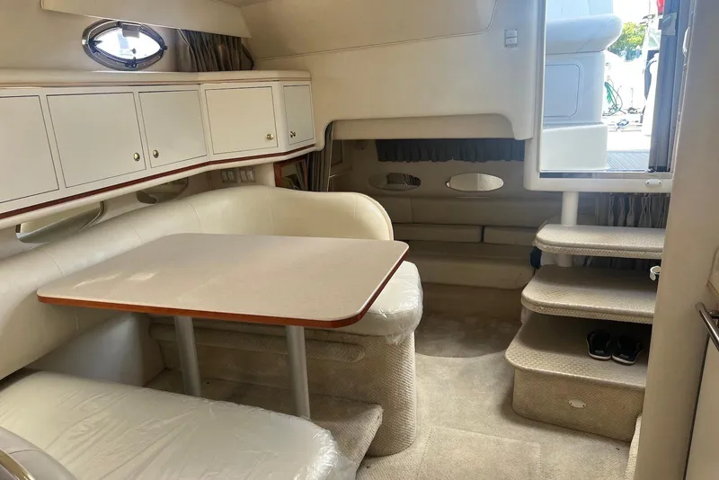 Slide: The Image of 2001 Sea Ray 310 Sundancer cabin interior with dining area and stairs. - 5
