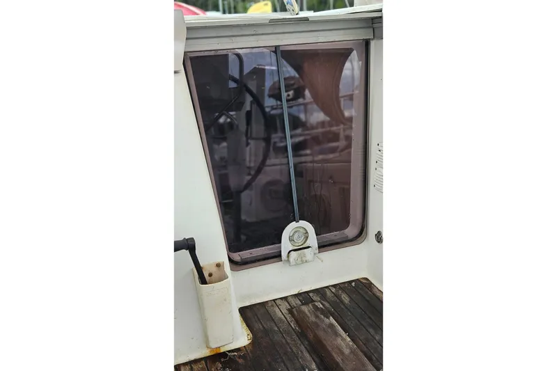 Slide: The Image of Cockpit view of 2010 Beneteau Oceanis 34 GT sailboat with canopy and marina background. - 18