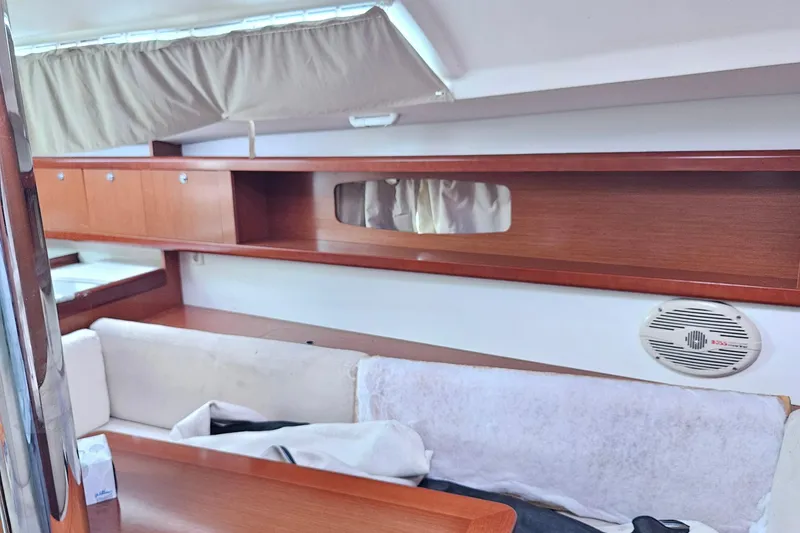 Slide: The Image of Interior view of 2010 Beneteau Oceanis 34 GT yacht, featuring cozy seating and kitchenette. - 20