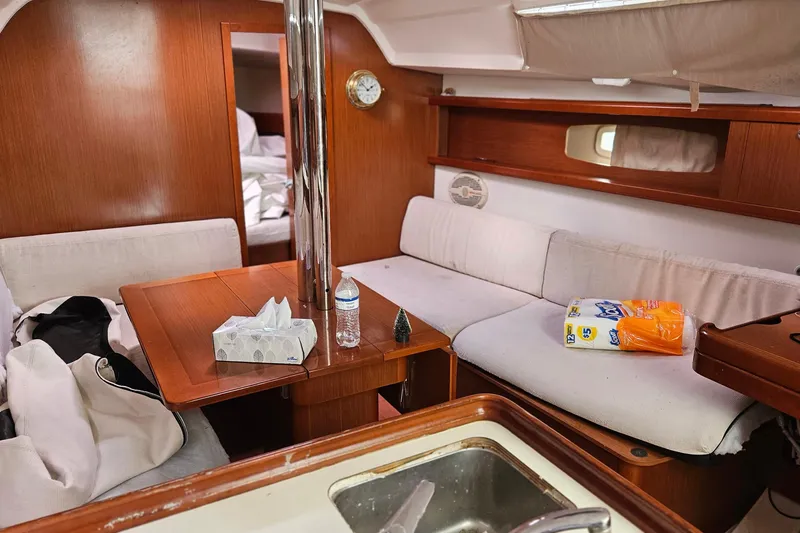 Slide: The Image of Interior of 2010 Beneteau Oceanis 34 GT yacht with cozy seating and wooden finishes. - 24