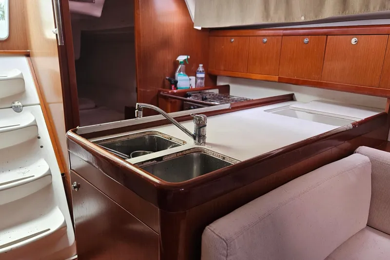 Slide: The Image of Interior of 2010 Beneteau Oceanis 34 GT yacht with kitchenette and seating area. - 25
